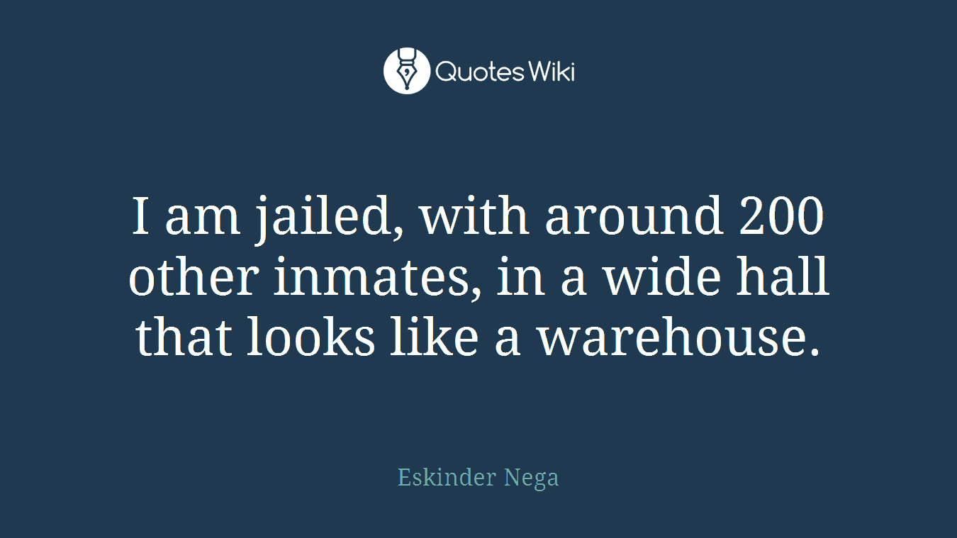 I am jailed, with around 200 other inmates, in a wide hall that looks like a warehouse.