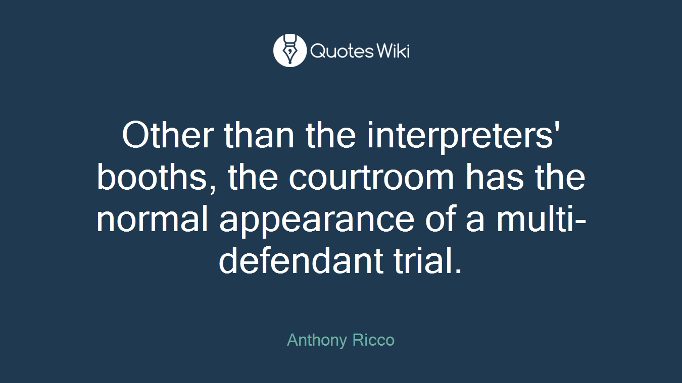 Other than the interpreters' booths, the courtroom has the normal appearance of a multi-defendant trial.